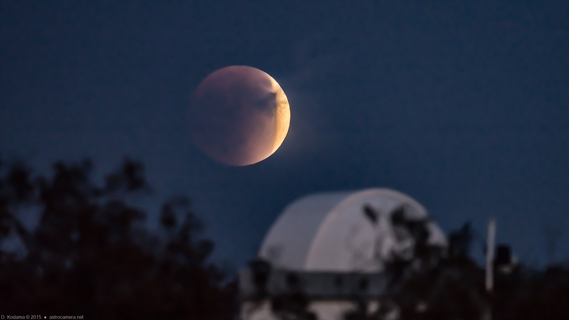 Eclipsed moon over observatory